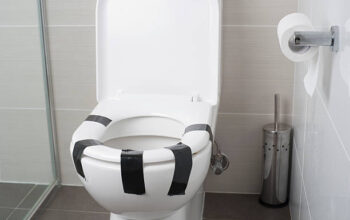 Toilet seat taped down with duct tape