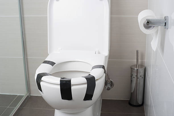 Toilet seat taped down with duct tape